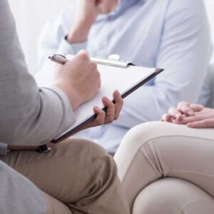 Psychiatrist with clipboard in session